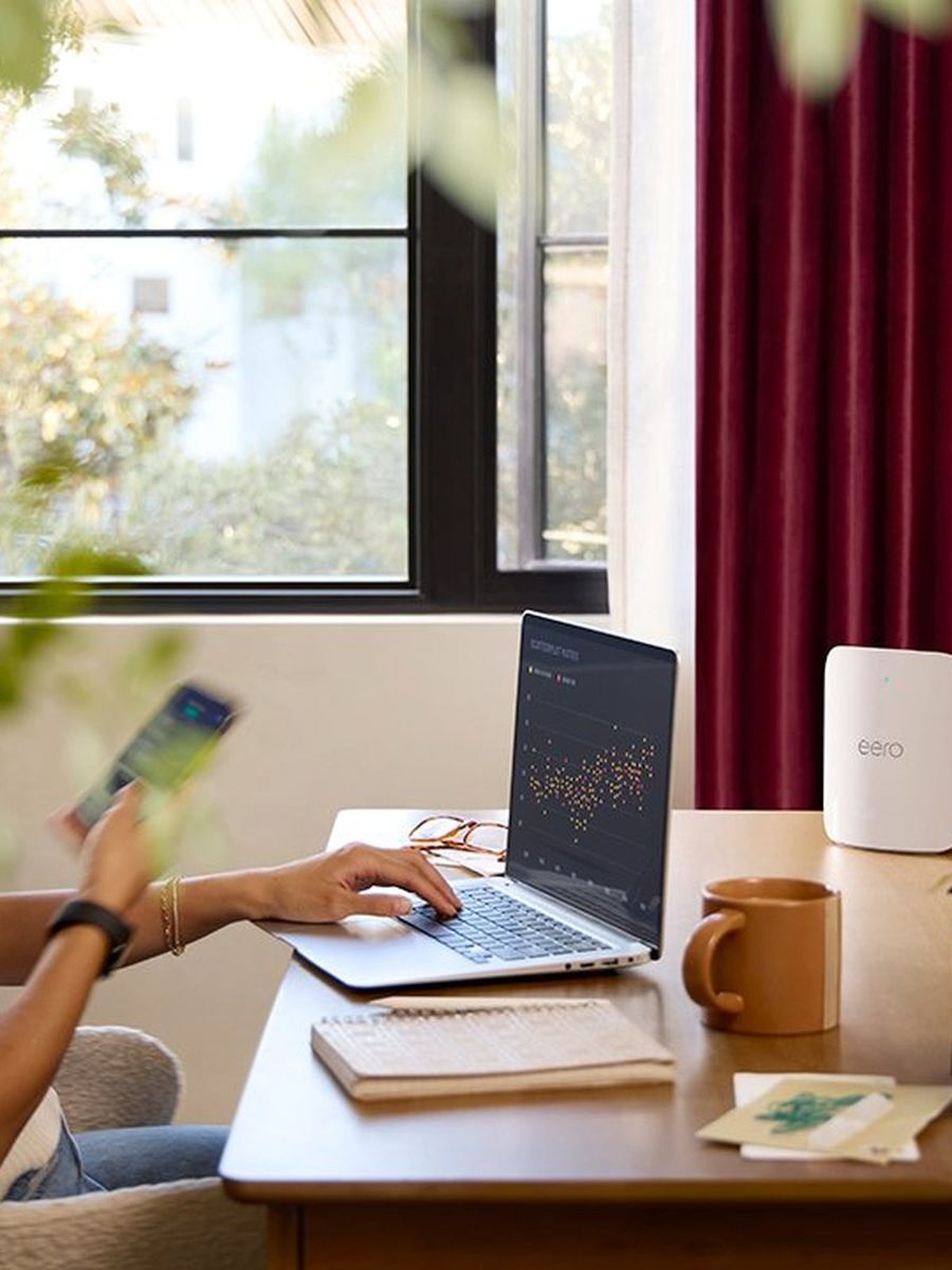 Mesh Wi-Fi access point on a desk in a home office